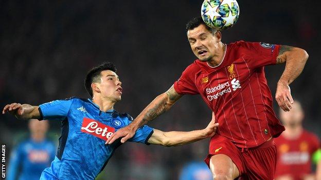 Dejan Lovren makes a header against Napoli