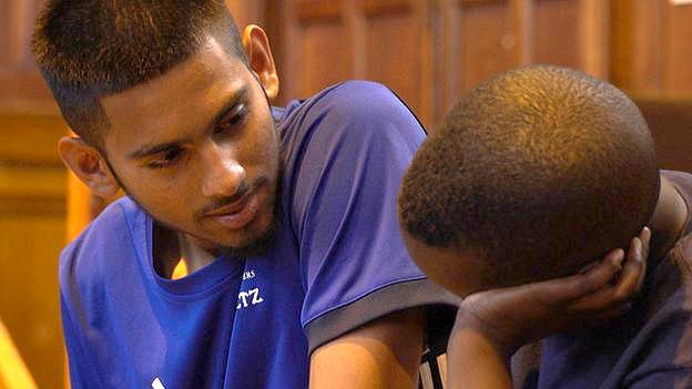 Abdus Salaam talking to another young man