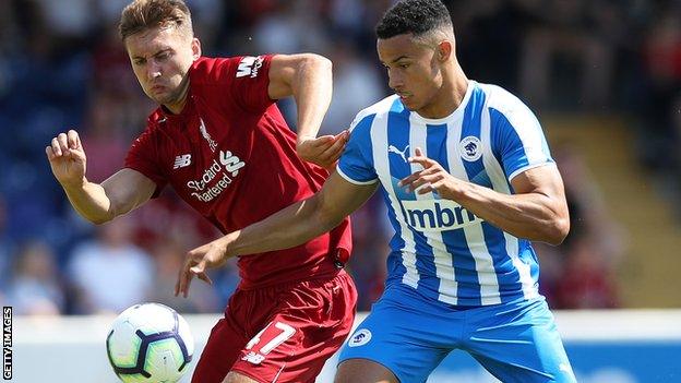 Nathaniel Phillips of Liverpool and Jordan Archer of Chester FC vie for the ball