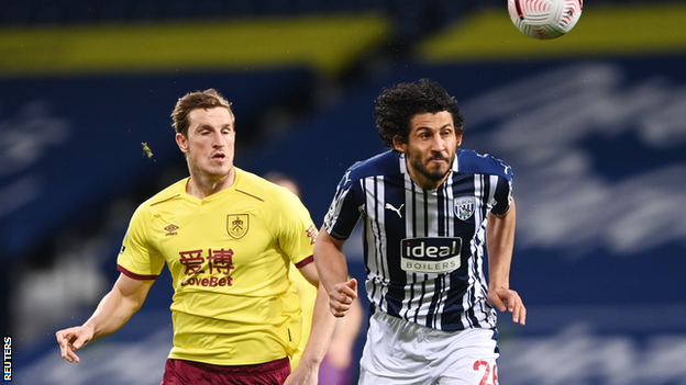 Ahmed Hegazi heads the ball ahead of Burnley's Chris Wood