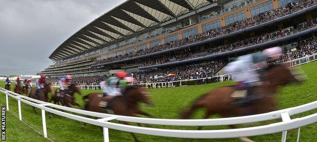 Horses race past the Grandstand at Ascot