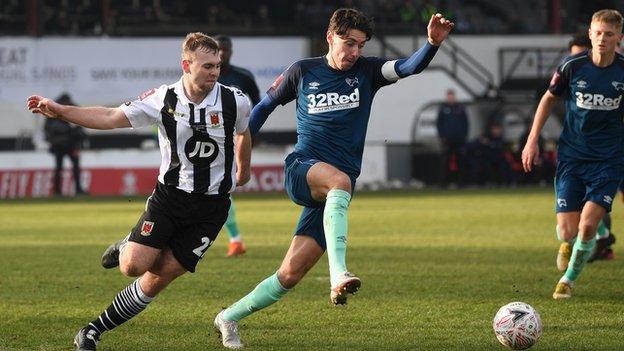 Isaac Hutchinson of Derby County is put under pressure by Connor Hall of Chorley FC during an FA Cup third round match