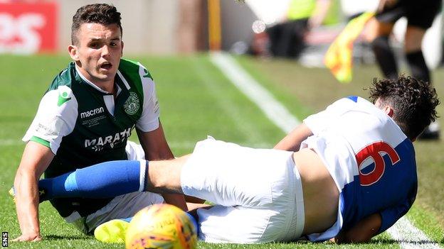 John McGinn makes a tackle for Hibernian against Blackburn Rovers