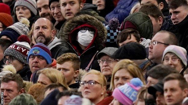 Shot of the crowd during Burnley's game against Tottenham with one fan wearing a face mask