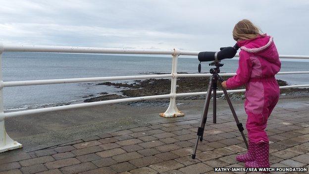 A child takes part in a watch in Aberystwyth