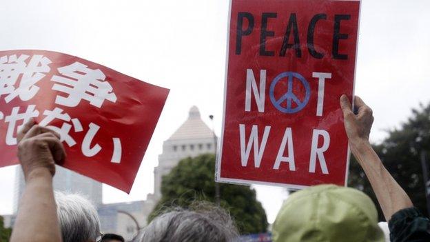 Protesters holding anti-war placards