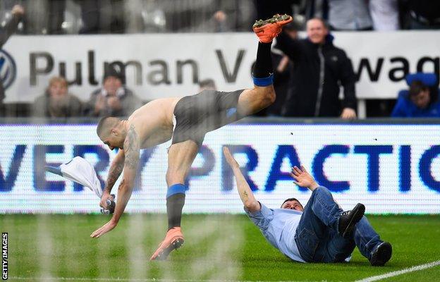 Aleksandar Mitrovic jumps over a fan