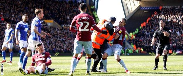 Jack Grealish on the floor after being attacked by a spectator