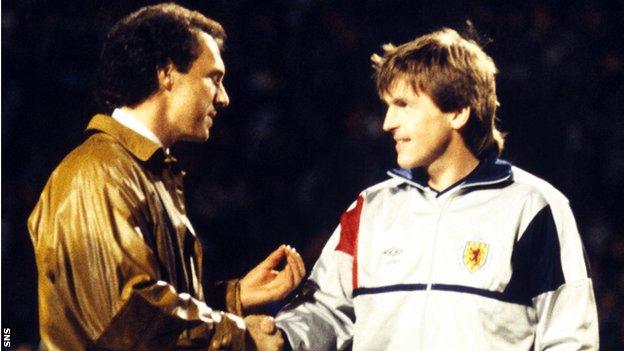 Franz Beckenbauer (left) presents Scotland's Kenny Dalglish with a trophy to commemorate his 100th cap