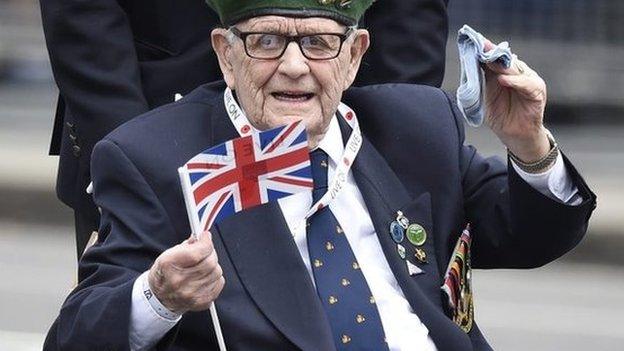 Veteran waves union jack during the parade