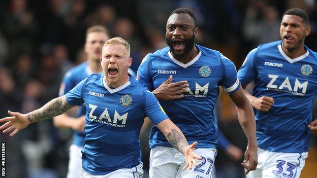 Macclesfield Town players celebrate scoring against Cambridge United