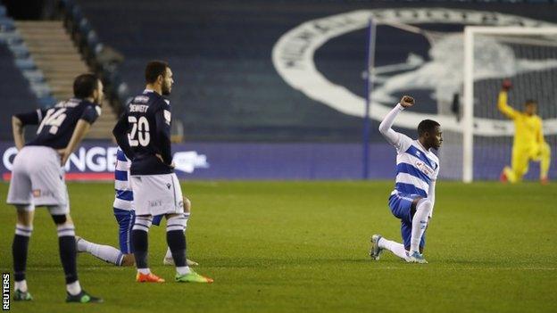 QPR players taking a knee before their game with Millwall on 8 December 2020, while Millwall players remained stood