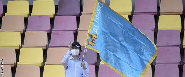 A fan shows his support for Fernando Alonso at first practice