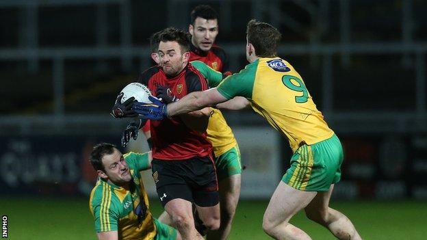 Down's Mark Poland in action against Hugh McFadden of Donegal