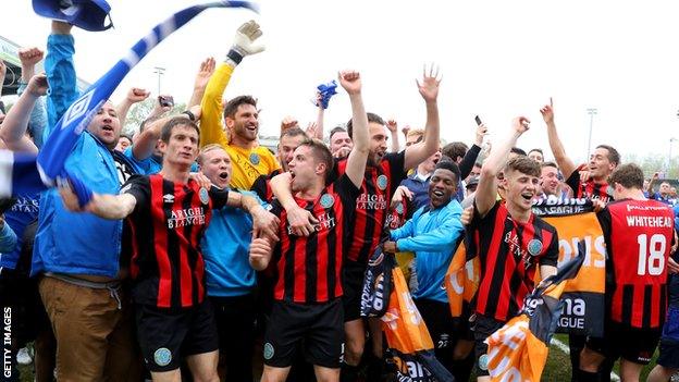 Macclesfield Town players and fans celebrate their promotion at the final whistle