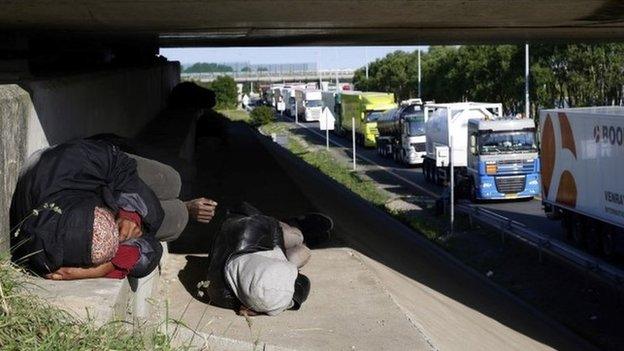 Migrants lying by the roadside in France