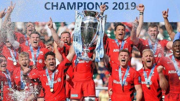 Brad Barritt and Owen Farrell of Saracens lift the trophy after winning the the Gallagher Premiership final against Exeter