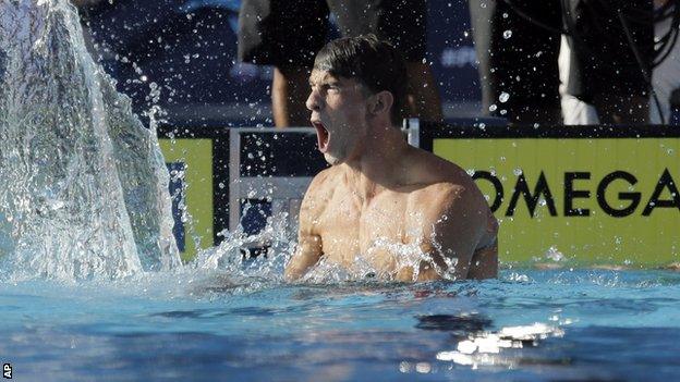 Michael Phelps celebrates his win in the 100m butterfly