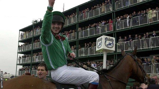 Ruby Walsh riding Papillon celebrates after victory in the 2000 Grand National at Aintree race course