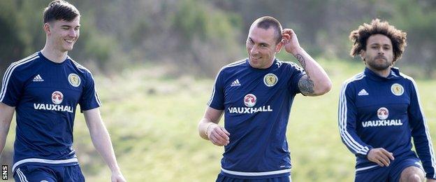 Kieran Tierney and Scott Brown share a joke in Scotland training, as Ikechi Anya looks on