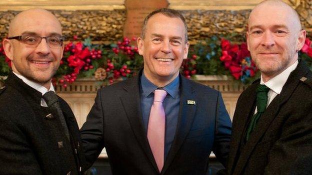 Joe Schofield (left) and partner Malcolm Brown (right) pose for a photograph before their marriage with Humanist Society Scotland's Ross Wright.