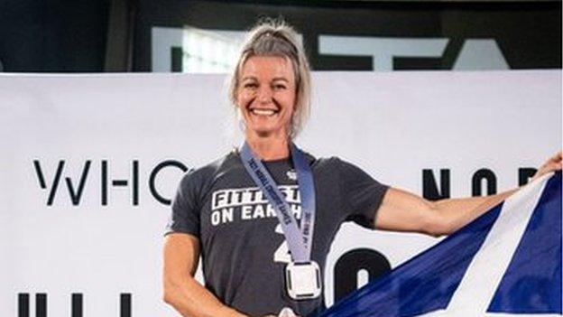 Ali Crawford proudly holding Scottish saltire as she claims second place in her category at the CrossFit Games 2021 in Wisconsin