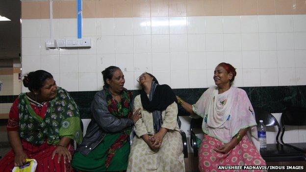 Relatives of victims wait at the hospital where they were being treated