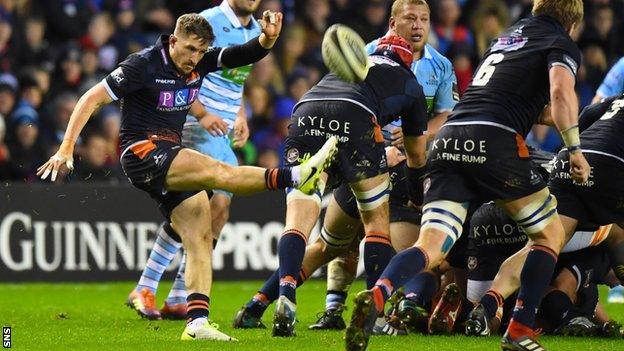 Henry Pyrgos launches a box-kick for Edinburgh against Glasgow