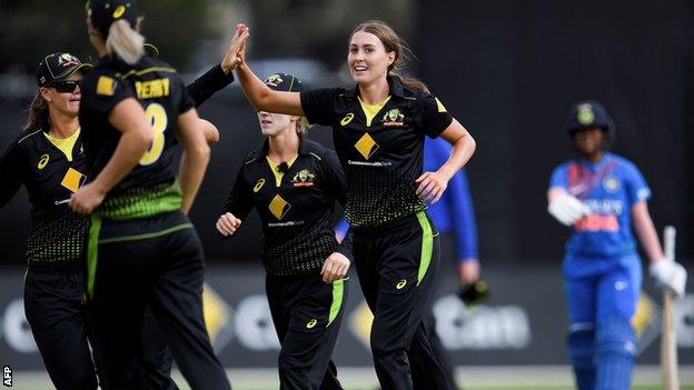 Tayla Vlaeminck celebrates with her Australia team-mates after dismissing India's Jemimah Rodrigues