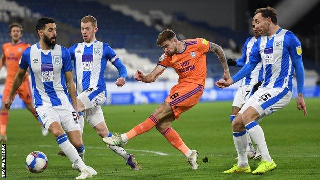 Cardiff's Joe Ralls gets a shot away despite the attentions of four Huddersfield players