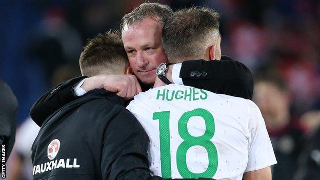 NI manager Michael O'Neill consoles Oliver Norwood and Aaron Hughes after the 0-0 draw with Switzerland in Basel