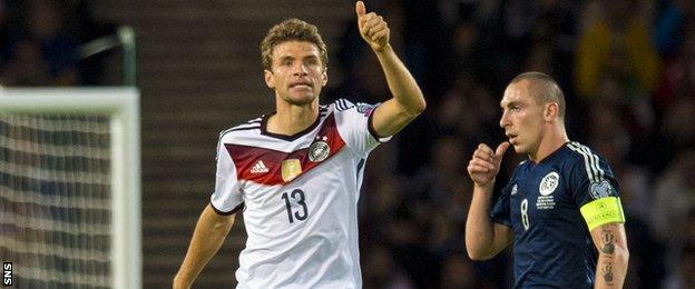 Thomas Muller (left) scored twice as Scotland fell short against Germany