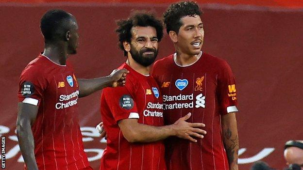 Sadio Mane, Mohamed Salah and Roberto Firmino embrace after a goal