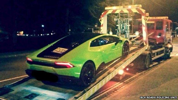 Lamborghini car being loaded on to a recovery truck outside Parkside Police Station in Cambridge