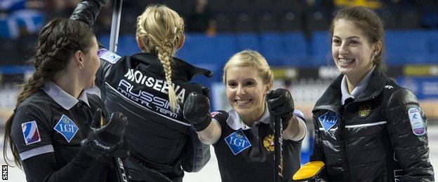 Victoria Moiseeva's Russian rink celebrate after beating Scotland