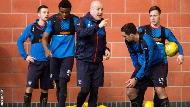 Mark Warburton leads an indoor training session at Murray Park