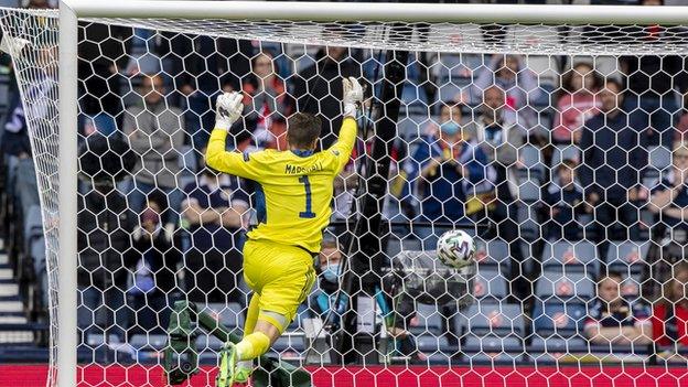 Marshall, who clearly wasn't expecting the Leverkusen striker strike from that distance, was sent scrambling...