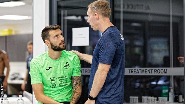 Steve Cooper talks to one of his players