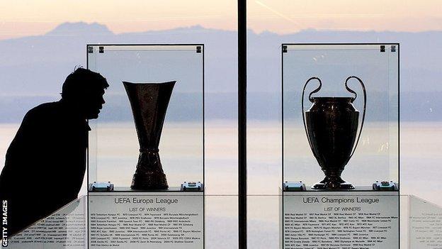 Champions League and Europa League trophies