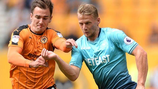 Stephen Kingsley battles for the ball with Wolves' Jed Wallace