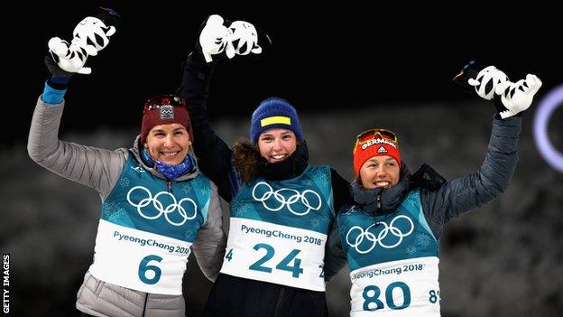 Anastasiya Kuzmina of Slovakia (left), Sweden's Hanna Oberg and Germany's Laura Dahlmeier