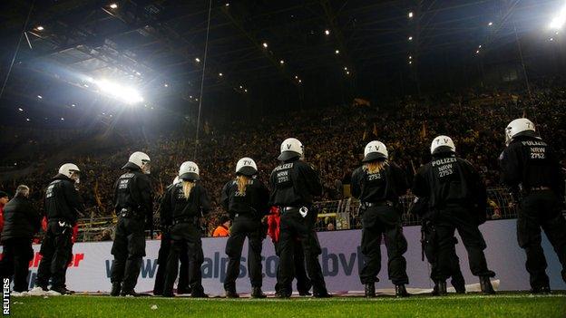 Police in front of Borussia Dortmund fans