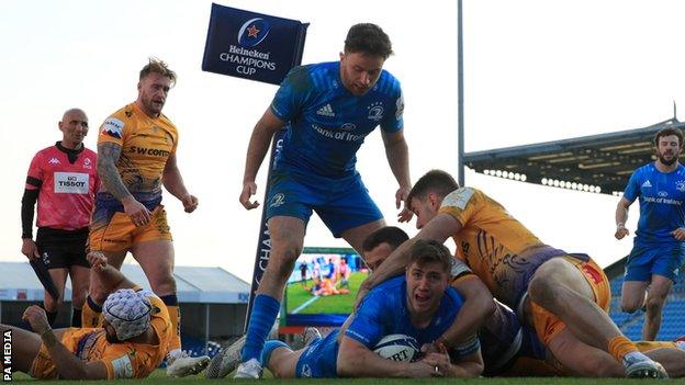 Jordan Larmour of Leinster scores their second try under pressure from Stuart Hogg of Exeter Chiefs