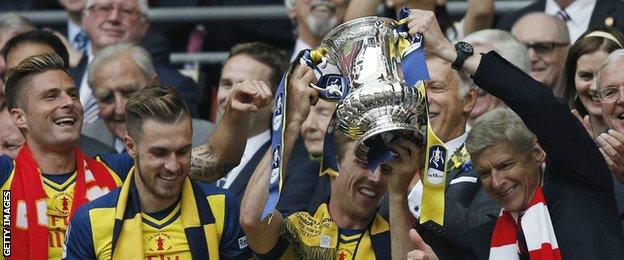 Arsene Wenger holds aloft the FA Cup in 2015