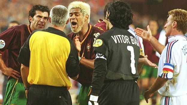 Portugal players surround the referee