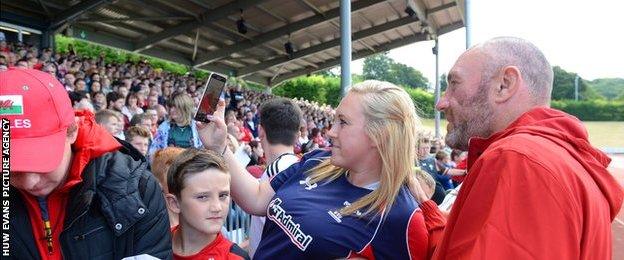 Wales forwards coach Robin McBryde (right) poses for photos with fans in Colwyn Bay