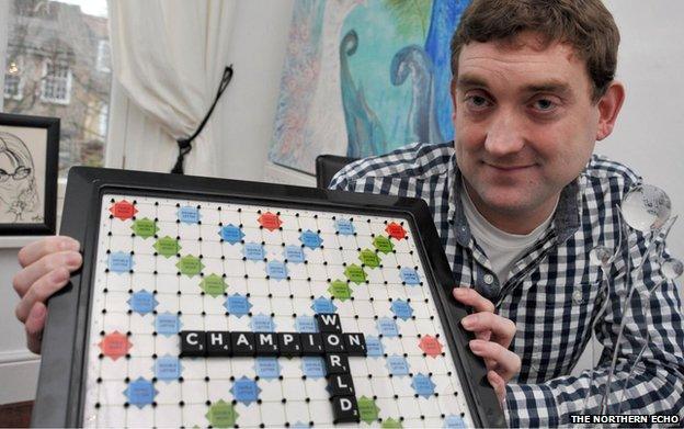 Craig Beevers and a Scrabble board with the words World Champion laid out in tiles