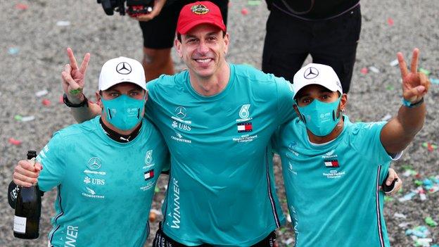 Toto Wolff celebrates with Valtteri Bottas and Lewis Hamilton