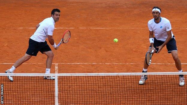 Daniele Bracciali of Italy and Potito Starace of Italy in action in the doubles against Max Mirnyi of Belarus and Mikhail Youzhny of Russia during day three of the Internazionali BNL d'Italia tennis 2014 on May 13, 2014