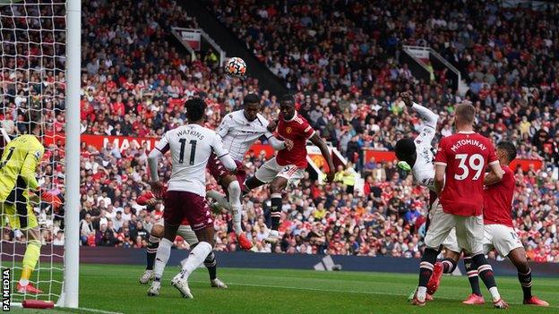 Aston Villa's Ezri Konsa heads over the bar in the match against Manchester United at Old Trafford